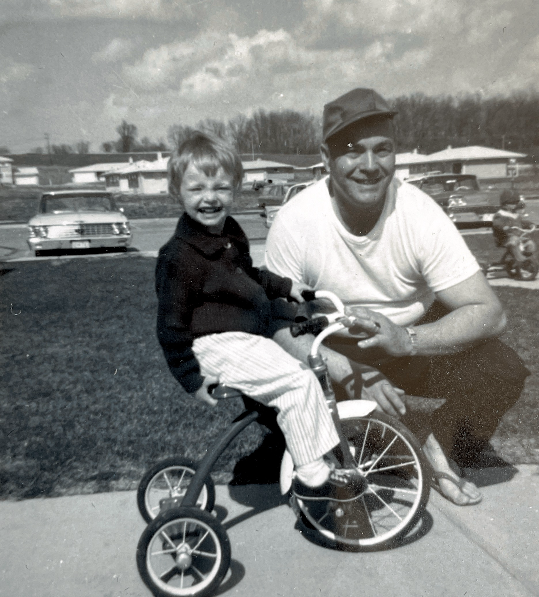 Author at age 2 ½ on a tricycle with grandpa Peterson